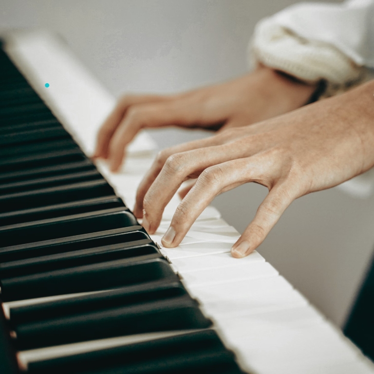Hands playing piano